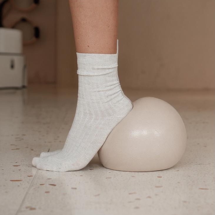 Person doing a tendon stretch with a ball